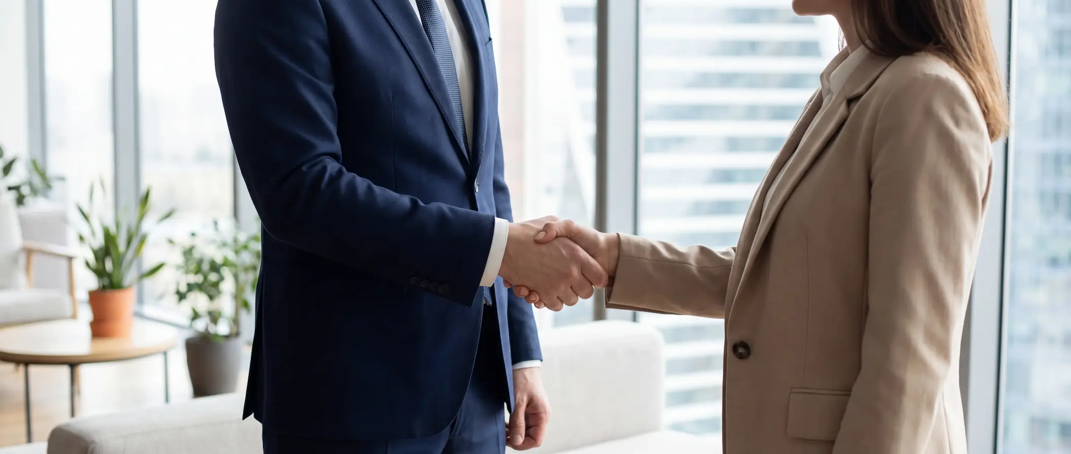 Деловое рукопожатие между двумя партнерами в офисе, символизирующее успешное заключение сделки или сотрудничество